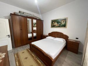 a small bedroom with a bed and a mirror at Klarisa Beach Apartment in Golem