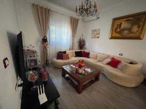 a living room with two couches and a coffee table at Klarisa Beach Apartment in Golem