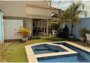 a swimming pool in the yard of a house at Pousada La Belle de Jour in Chapada dos Guimarães
