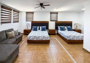 a living room with two beds and a couch at White House Cabo in Cabo San Lucas +29 photos