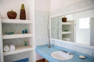 a bathroom with a sink and a mirror at 2BR Steps to Malecón Panoramic views Private pool in La Paz