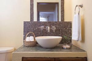 a bathroom with a bowl sink and a mirror at 20 ft to malecón, downtown, private Pool in La Paz