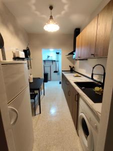 a kitchen with a sink and a dishwasher in it at El Corazón de Gredos II in Arenas de San Pedro