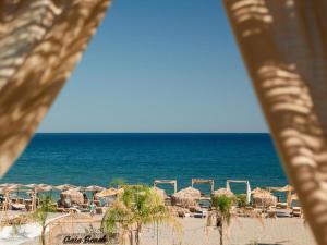 a view of a beach with umbrellas and the ocean at Alia Beachfront Suites and Spa in Haraki +161 photos