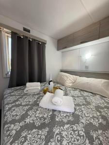 a bedroom with a bed with towels on it at Glykofilousa Tiny Ηouse in Petra