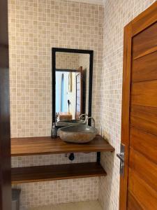 a bathroom with a sink and a mirror at The Aura Inn in Kerobokan +12 photos