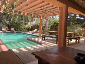 a swimming pool with a pergola and a table at Casa mia in Saly Portudal