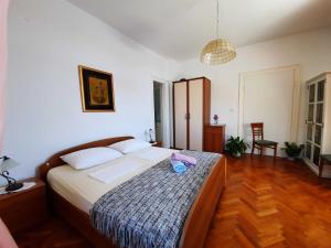 a bedroom with a bed with a pink phone on it at Apartments Kirigin in Dubrovnik