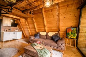 a living room with a couch in a log cabin at La'Familia in Batumi +39 photos