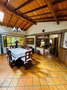 a large dining room with a table and chairs at Magical farmhouse near Arví Park in Mazo