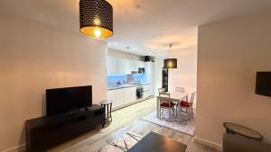 a living room with a television and a dining room at Near Wembley Stadium ,london Uk BOOk now in London