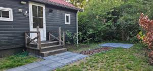 a house with a staircase leading to a door at De Kleine kriemelkuil-Het Koentje in Ermelo