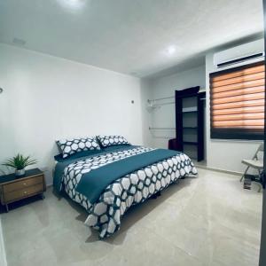 a bedroom with a large bed and a window at Casa venue in Mérida