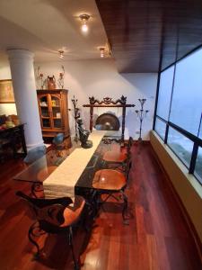 a dining room with a table and chairs and a fireplace at Black Shark Apartments in Lima