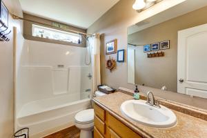 a bathroom with a sink and a shower and a toilet at Soldotna Home with Yard, Walk to Kenai River! in Soldotna +22 photos