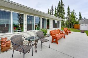 a patio with chairs and a table and benches at Soldotna Home with Yard, Walk to Kenai River! in Soldotna