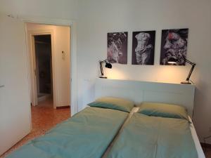a bed in a room with two pictures on the wall at Golden House Venice Yellow - Mirano in Mirano