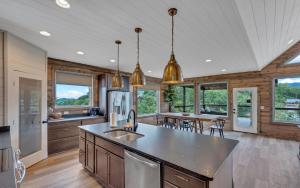a kitchen with a large island in a room with windows at Hang Yer Hat in Sevierville