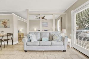 a living room with a couch and a dining room at Luxe Guest Suite Near The Emerald Coast of PCB in Panama City