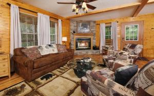 a living room with a couch and a fireplace at Cozy Bear Camp in Sevierville