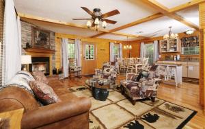a living room with a couch and a table at Cozy Bear Camp in Sevierville