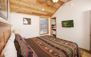 a bedroom with a bed in a room at Coppertop View in Gatlinburg +50 photos