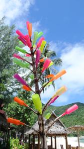 a tree made out of different colored kites at Bottle Beach 2 Bungalows in Bottle Beach