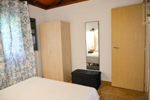 a bedroom with a bed and a door and a mirror at Casa Juncal in Tarifa