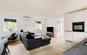 a living room with a couch and a tv at 3 Bedroom Beautiful Home In Tarm in Tarm