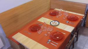 リャンサにあるApartamento Palandriuの木製テーブル(赤皿、メガネ付)