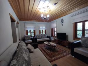a living room with a couch and a tv at Asiye Hanım Konağı in Trabzon