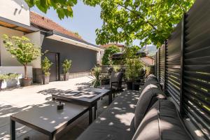 a patio with tables and benches on a building at Apartments AMALFI Old Town FREE Parking in Sarajevo