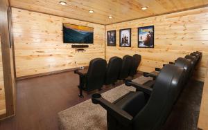 a room with wooden walls with chairs and a tv at Rustic Timber in Sevierville +42 photos