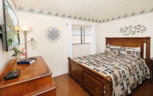 a bedroom with a bed and a desk and a television at Oak Square 305 in Gatlinburg +8 photos