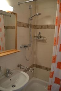 a bathroom with a shower and a sink and a tub at Ferienwohnung Marina Wendtorf App. 6110 in Wendtorf