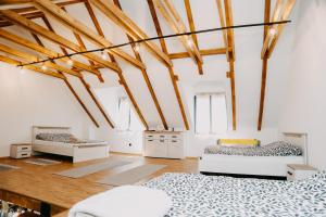 two beds in a room with wooden beams at Villa Jelica in Konjic +21 photos