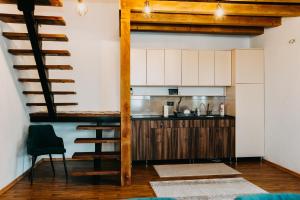 a kitchen with a loft conversion with a table and a counter at Villa Jelica in Konjic