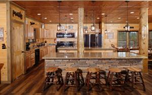 a kitchen with a large island with bar stools at Bigger Bear Views Lodge in Gatlinburg
