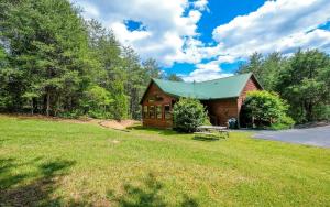 a barn with a picnic table in the grass at Dogwood Acres in Pigeon Forge