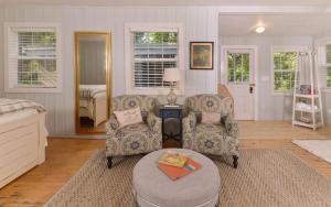 a living room with two chairs and a table at On River Time in Gatlinburg
