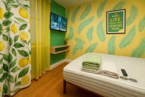 a room with a bed and a wall with oranges at Lemon Vibes room in New York
