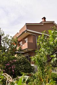a house with bushes and trees in front of it at Apartments with parking space Krasica, Rijeka - 23488 in Krasica