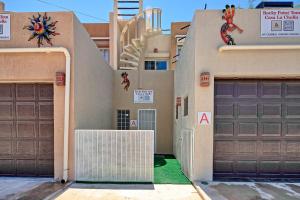 a house with two garage doors and a staircase at 3 Story Home 3BR 2BA with Rooftop View and Heated Pool in La Choya