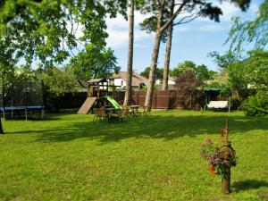 a park with a playground and a fire hydrant in the grass at Romance in Ventspils