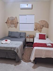 Ένα ή περισσότερα κρεβάτια σε δωμάτιο στο Casa vila costeira Guriú térreo