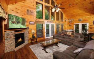 a living room with a fireplace in a log cabin at Amazing Grace in Sevierville