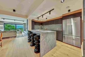 a kitchen with a large island with a counter top at KOKI Apartment 4 in Falls Creek