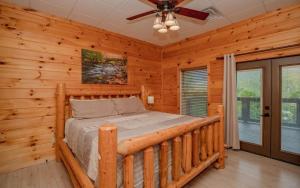 a bedroom with a bed in a log cabin at Absolute Heaven in Gatlinburg