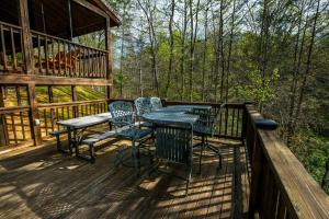 a table and chairs on the deck of a cabin at Amazing Grace in Sevierville
