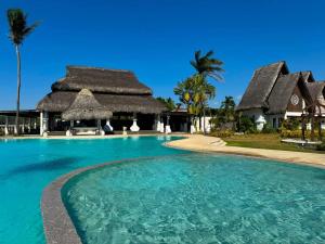 a swimming pool in front of a resort at Playa Tropical Resort Hotel in Currimao